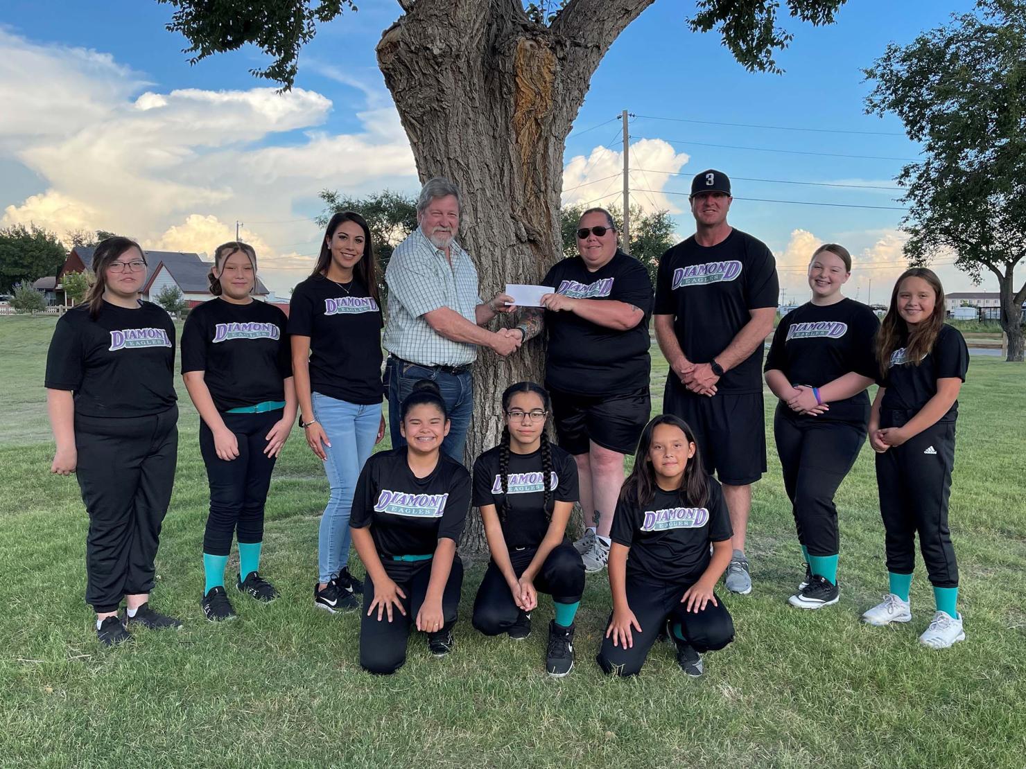 Enstor Grama Ridge Plant Manager Steve Maker presents a check to Diamond Divas Head Coach Jennifer Buford.Enstor Grama Ridge Plant Manager Steve Maker presents a check to Diamond Divas Head Coach Jennifer Buford. The Divas are a Diamond Eagles USSSA 12u softball team located in Hobbs, New Mexico. 